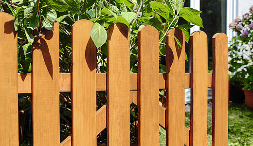 Ein Holz-Zaun in einem Garten  Holz-Zäune wetterfest bauen und streichen